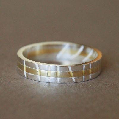 Sterling silver and 18ct gold engagement ring made in collaboration. Wire wrapped by the client to create a negative echo of a companion ring. June 2018